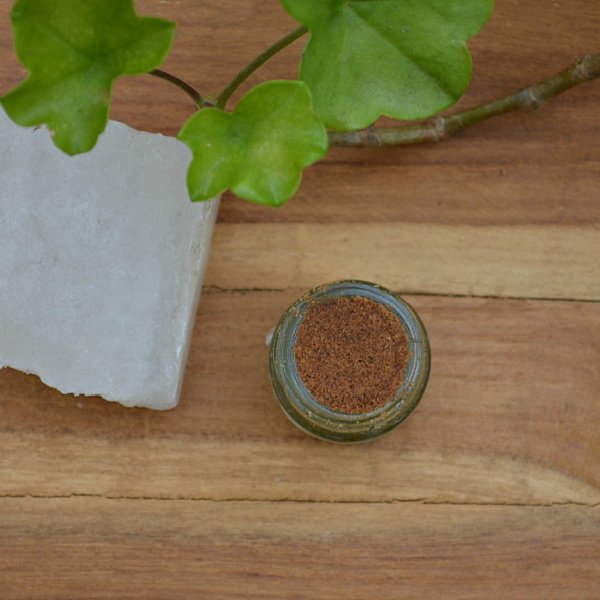 Applying alum crystal deodorant to clean underarm